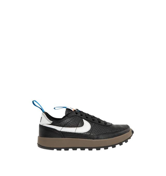 Image 1 of 5 - BLACK - Tom Sachs x Nike Unisex NikeCraft General Purpose Shoe "Demerits" is crafted from durable leather and features a low-profile silhouette inspired by everyday utility and wearability. Designed with blue nylon herringbone pull straps, a premium microfiber collar, and an embroidered "NIKE" logo in Tom Sachs' handwriting at the heel, this edition references the designer's "Demerits" concept. Main Material: Leather Upper. Collar: Premium Microfiber. Midsole: Gum Rubber with EVA Foam C