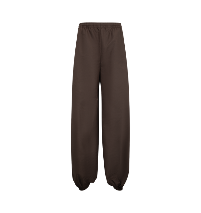 Image 1 of 3 - BROWN - Balenciaga Women's Balloon Tracksuit Pant is crafted from nylon and features the brand's signature balloon silhouette with an exaggerated, voluminous shape. Designed with a relaxed fit and sportswear-inspired construction, these statement track pants combine technical fabrication with Balenciaga's avant-garde proportions for a modern, oversized look. Main Material: Nylon. Made in Italy.