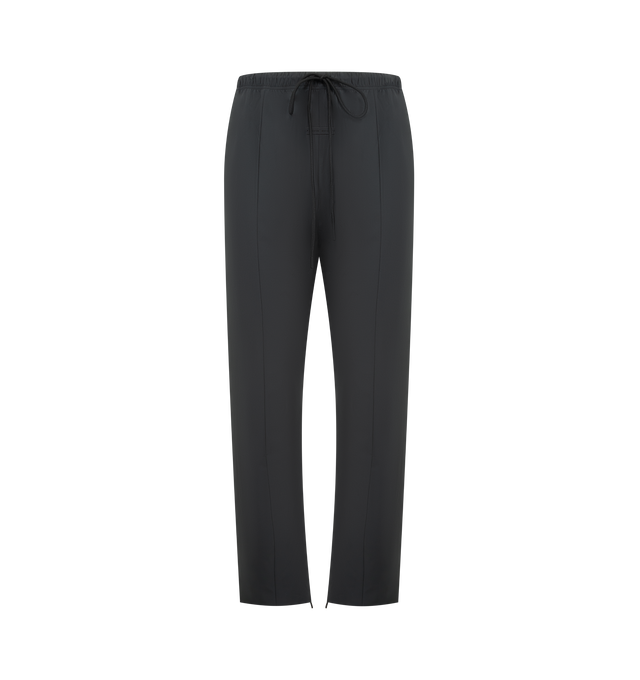 Image 1 of 3 - BLACK - FEAR OF GOD ESSENTIALS Tech Nylon Relaxed Track Pant featuring a tech nylon-spandex blend, pintuck relaxed-leg silhouette, metallic 3M-printed Essentials logo on leg, encased elastic waistband with elongated drawcords, side seam pockets and a Fear of God Essentials rubberized label stitched at the center front. 16% spandex, 84% nylon.