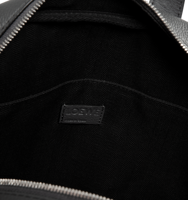 Image 3 of 3 - GREY - LOEWE Military Backpack featuring one main compartment, an additional section under a fold over flap that closes with a magnetic fastening, back, shoulder or top handle carry, large internal pocket to accommodate a laptop, herringbone cotton canvas lining and embossed Anagram. 15.4 x 11.2 x 4.3 inches. 100% soft grained calfskin. Made in Spain.