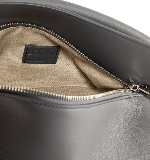 Image 3 of 3 - GREY - LOEWE Small Puzzle Edge Bag in calfskin featuring geometric lines, cuboid form, overlapped panels with single stitch lines, shoulder, crossbody or hand carry, detachable and adjustable strap, zip closure with calfskin pull, one external zip rear pocket, one internal slip pocket, herringbone cotton canvas lining and embossed Anagram. Soft grained calf. 16.5 cm x 24 cm x 10.5 cm. Made in Spain.
