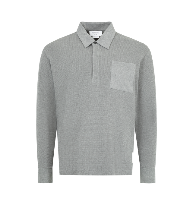 Image 1 of 3 - GREY - THOM BROWNE Waffle-Texture Rugby Polo Shirt featuring waffle knit cotton, signature name tag appliqu, point collar, concealed half placket, contrast chest pocket, ribbed cuffs, vented sides with striped grosgrain trim and pullover style. Cotton. Made in Japan.