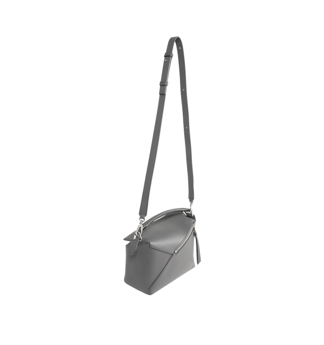 Image 2 of 3 - GREY - LOEWE Small Puzzle Edge Bag in calfskin featuring geometric lines, cuboid form, overlapped panels with single stitch lines, shoulder, crossbody or hand carry, detachable and adjustable strap, zip closure with calfskin pull, one external zip rear pocket, one internal slip pocket, herringbone cotton canvas lining and embossed Anagram. Soft grained calf. 16.5 cm x 24 cm x 10.5 cm. Made in Spain.