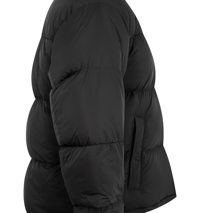 Image 3 of 3 - BLACK - Canada Goose Men's Sterling Puffer Coat is crafted from lightweight plain-weave poly fabric with a smooth matte finish and features a regular-fit silhouette with wide quilted baffles. Designed for cold-weather protection, this down-filled coat is finished with a fixed hood with hidden cord lock, a concealed snap placket over a two-way zip closure, an exposed bottom snap, elasticized cuffs, and an adjustable drawcord hem. Functional storage includes two exterior zippered welt pockets,