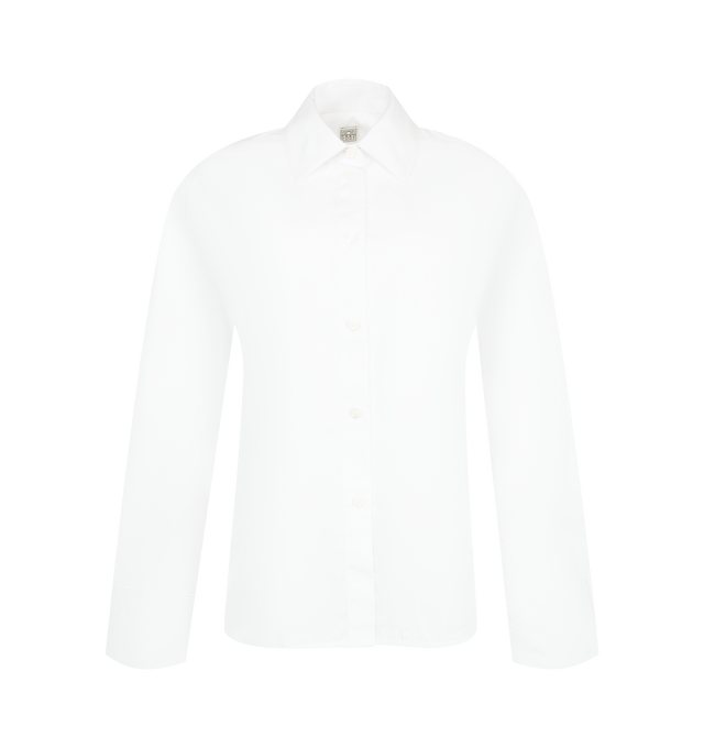 Image 1 of 2 - WHITE - Toteme Women's Boxy Poplin Shirt is crafted from crisp cotton poplin and features a relaxed boxy silhouette with a classic point collar, button-front closure, long sleeves, and buttoned cuffs. This designer shirt combines clean tailoring with Toteme's signature minimalist aesthetic, creating a versatile wardrobe staple for effortless everyday dressing. Main Material: 100% Cotton.