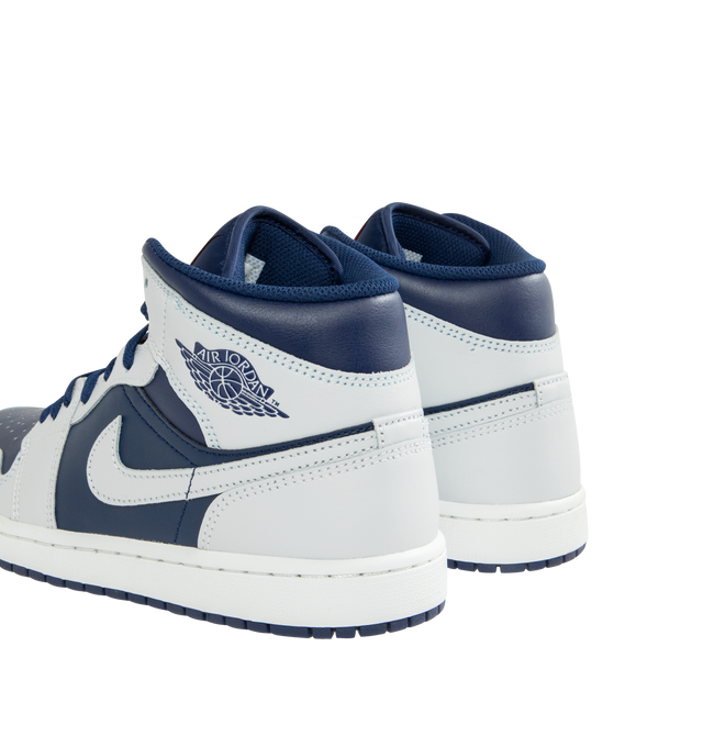 Image 3 of 5 - NAVY - JORDAN Air Jordan 1 Mid Sneaker featuring mid-top, leather, synthetic leather, textile upper, foam midsole, Nike Air cushioning and rubber outsole with pivot circle.