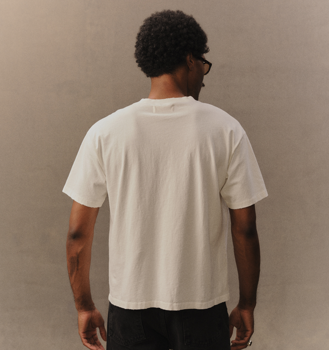 Image 6 of 6 - WHITE - Cherry LA Men's Henley T-Shirt is crafted from cotton and features a boxy-fit silhouette with a classic Henley neckline. Designed with embroidered detailing at the front, this elevated everyday essential combines relaxed proportions with signature Cherry LA styling. Main Material: Cotton. Made in Los Angeles, California.