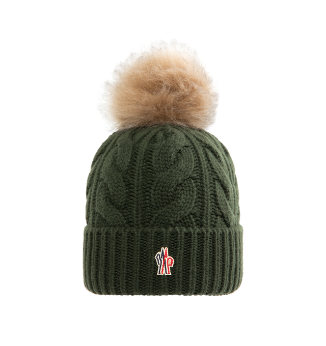 Image 1 of 2 - GREEN - MONCLER GRENOBLE Wool & Cashmere Beanie with Pom Pom featuring a wool and cashmere blend, cable knit and fisherman's rib knit fold, gauge 3, long-haired sheepskin pom-pom and logo patch. 70% virgin wool, 30% cashmere. Made in Italy.