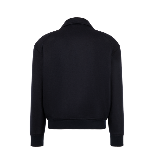 Image 2 of 3 - NAVY - Jil Sander Men's Padded Zip-Up Wool Jacket is crafted from technical faille and features a relaxed-fit silhouette with dropped shoulders, a stand collar, and a pack-away hood concealed within the collar. Designed for versatile everyday wear, this lightweight jacket is finished with a front zip closure, side welt pockets, a drawstring waist, elasticized cuffs, and a signature Jil Sander logo application at the sleeve. Main Material: Wool. Made in Italy.