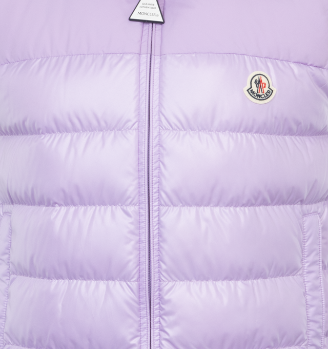 Image 3 of 5 - PURPLE - MONCLER Cerces Down Vest featuring stowaway hood at stand collar, two-way zip closure, felted logo patch at chest, zip pockets, elasticized hem, zip pocket at interior, fully lined and logo-engraved silver-tone hardware. 100% polyester. Fill: 90% duck down, 10% feathers. 