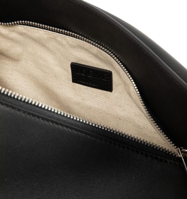 Image 4 of 4 - BLACK - LOEWE Medium Puzzle Edge Bag featuring distinctive geometric lines, cuboid form, shoulder, crossbody or hand carry, detachable and adjustable strap, zip closure with calfskin pull, one external zip rear pocket, two internal slip pockets, herringbone cotton canvas lining and embossed Anagram. Classic calf. Made in Spain.