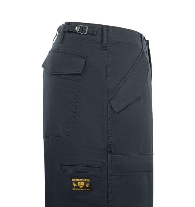 Image 3 of 3 - NAVY - HUMAN MADE Wide Military Pants featuring wide fit, adjustable waist tab, front zip closure, front and back flap pockets with snap button, iPhone size utility pockets on legs, multi-pockets on the front and back and adjustable tape at the hem. 100% cotton.