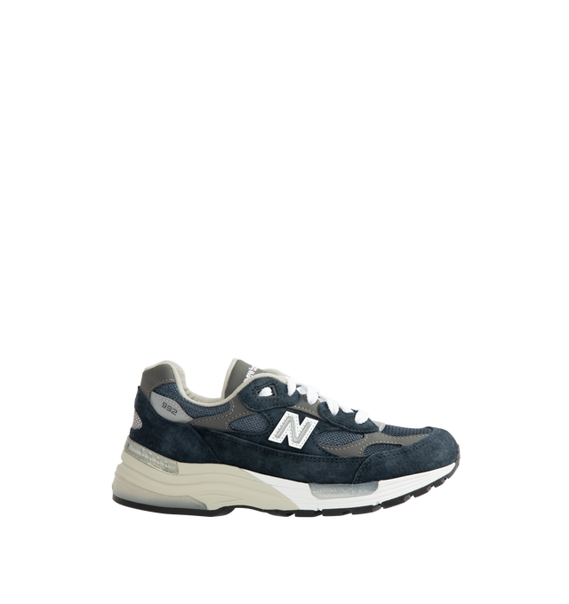 Image 1 of 5 - NAVY - New Balance Unisex Made in USA 992 Core Sneakers feature a mesh upper with premium suede overlays. ABZORB cushioning at the heel and forefoot absorbs impact, while a combined ENCAP and C-CAP midsole provides support. Reflective details and an Ndurance rubber outsole complete the design. Upper: Mesh and Suede. Sole: Rubber. Made in USA with 70% or more domestic value. *Unisex style in men's sizing.