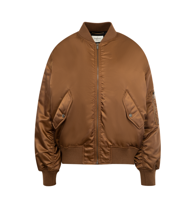 Image 1 of 3 - BROWN - SAINT LAURENT Bomber Jacket featuring drop shoulders, rib-knit trims, viscose and cotton lining, front zip closure, two welt pockets with snap-button flat at the front, one zip utility pocket at the sleeve, two inner snap-button welt pockets, baseball collar and ribbed trims. 100% polyamide. Made in Italy.