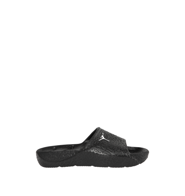 Image 1 of 4 - BLACK - JORDAN Franchise Shower Slides featuring a single piece of robust yet flexible foam, quick-drying, drainage holes throughout the outsole, a raised elephant print that helps add traction to the footbed, herringbone tread pattern on the foam outsole and Jumpman branding.