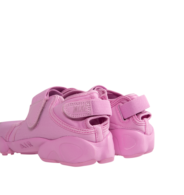 Image 3 of 5 - PINK - NIKE Air Rift Sneaker featuring hook-and-loop straps on the midfoot and heel, Nike Air unit in the heel combined with plush foam, rubber detailing on the outsole, upper features a blend of elastane, polyester and nylon materials for a flexible fit and split toe design.