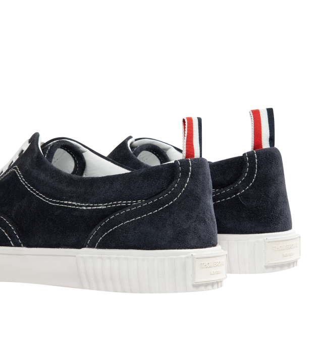 Image 3 of 5 - NAVY - THOM BROWNE Suede Heritage Trainer featuring lace up closure, rubber sole, leather lining and signature striped grosgrain loop tabs. Suede leather. Made in Italy.