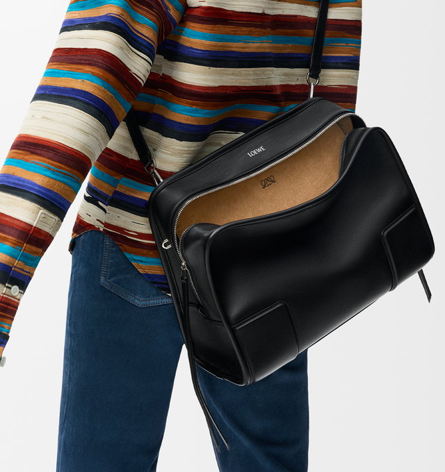 Image 10 of 16 - BLACK - Loewe Amazona 180 large bag takes on a relaxed silhouette anchored by a single toron top handle. It is designed to be carried open, while a concealed closure secures the main compartment. Removable shoulder and crossbody straps make it highly versatile. This large version is crafted in soft calfskin. Three carry options: short handle, removable shoulder strap and crossbody. Features zip closure with two leather zip pullers, two compartments, main compartment closed with magnetic clo