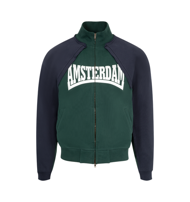 Image 1 of 2 - GREEN - VETEMENTS Patched Zip-Up Jacket featuring cotton-blend French terry, paneled construction, raw edge throughout, rib-knit stand collar, hem, and cuffs, two-way zip closure, embroidered text at front, welt pockets at waist, raglan sleeves and logo embroidered at back collar. 80% cotton, 20% polyester. Made in Portugal.