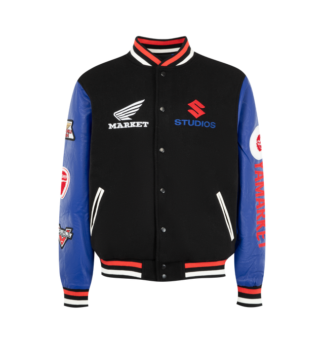 Image 1 of 4 - MULTI - Market Men's Sponsorship Varsity Jacket is crafted from premium materials and features a classic varsity silhouette with a snap-button front, ribbed striped trims, side pockets, and embroidered Sponsorship-inspired graphics throughout. This designer varsity jacket combines vintage athletic influences with Market's signature playful streetwear aesthetic, creating a standout layering piece for everyday wear. Premium Fabric Blend. Shell: 50% Polyester; 50% Wool; Sleeves: Synthetic Leathe
