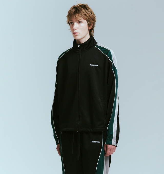 Image 3 of 4 - BLACK - NAHMIAS Ollie Track Jacket featuring zip front closure, stand collar, logo embroidery on chest, front slit pockets and stripes and piping down arms. 100% polyester.