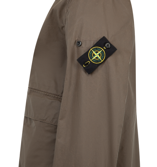 Image 3 of 4 - BROWN - STONE ISLAND Coach Jacket featuring collar with snap to wear standing, top-entry bellows hand pockets with flap and concealed snap, with overlapping angled pockets, eyelets under back armholes, Stone Island badge on left sleeve, adjustable cuffs with snap and two-way zipper fastening under snap placket. 65% polyester, 35% cotton.