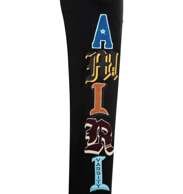 Image 5 of 5 - BLACK - AMIRI Varsity Patch Sweatpant featuring multicoloured appliqus, elasticated waistband with drawstring, relaxed fit, side pockets and back welt pocket. 100% cotton.