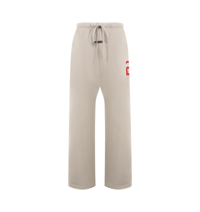 Image 1 of 3 - NEUTRAL - FEAR OF GOD ESSENTIALS Lounge Sweatpant featuring core fleece treated with a vintage wash, wide-leg silhouette, a 26 HD print graphic on the leg, encased elastic waistband with elongated drawcords, side seam pockets and a Fear of God Essentials rubberized label stitched at the center front. 100% cotton.
