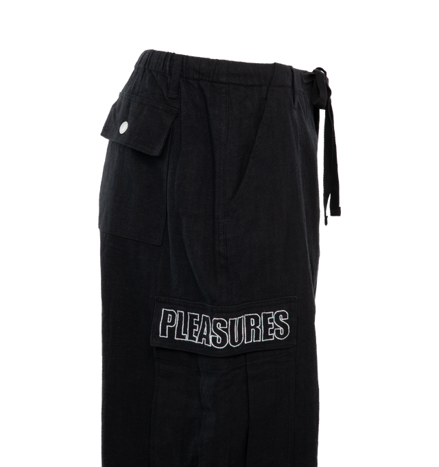 Image 3 of 3 - BLACK - PLEASURES Visitor Wide Cargo Pants featuring adjustable ties at leg opening, heavyweight faux linen, knee darts, cargo pockets, PLEASURES logo embroidery on cargo pockets and oversized fit. 85% ramie, 15% cotton. 