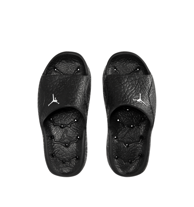 Image 4 of 4 - BLACK - JORDAN Franchise Shower Slides featuring a single piece of robust yet flexible foam, quick-drying, drainage holes throughout the outsole, a raised elephant print that helps add traction to the footbed, herringbone tread pattern on the foam outsole and Jumpman branding.