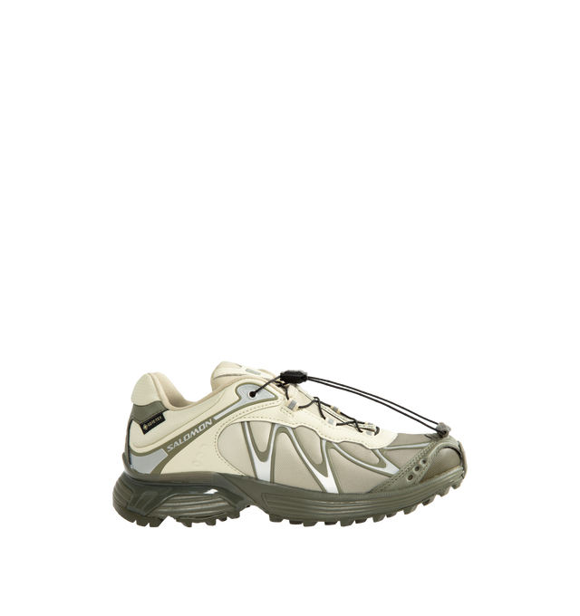 Image 1 of 5 - GREEN - Salomon Unisex XT-Whisper GORE-TEX Sneakers reimagine a trail-inspired icon with a modern performance-driven design. Crafted with a waterproof and breathable GORE-TEX membrane, this versatile style is engineered for all-weather wear while maintaining lightweight comfort and protection.Main Material: Synthetic and Textile Upper. Membrane: GORE-TEX Waterproof Protection. Closure: Quicklace System. Outsole: Contagrip Rubber.*Unisex style in men's sizing.