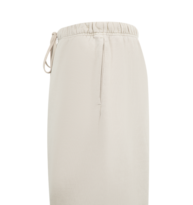 Image 3 of 4 - GREY - FEAR OF GOD ESSENTIALS Heavy Fleece Lounge Sweatpant featuring 520gsm heavy fleece treated with a pigment dye to create rich depth of color, wide-leg silhouette, bold Essentials script logo on the leg, encased elastic waistband with elongated drawcords, side seam pockets and a Fear of God Essentials rubberized label stitched at the center front. 100% cotton.