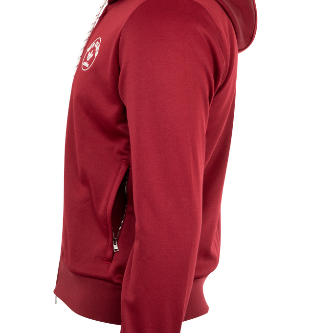Image 3 of 3 - RED - Adidas x Wales Bonner Logo Hoodie featuring drawstring hood, two-way front zip placket, long sleeves with ribbed cuffs, chest graphic logo and ribbed hem. 61% polyester, 39% cotton.