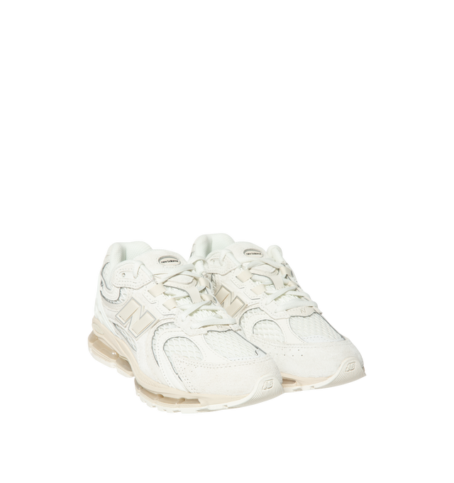 Image 2 of 5 - WHITE - New Balance 1954R Unisex Sneakers feature a suede and mesh upper inspired by the 2002 and 1906 models, combining breathable mesh with synthetic and pig suede overlays. ABZORB midsole cushioning absorbs impact through a combination of cushioning and compression resistance, while a traditional lace-up closure provides an adjustable fit. Upper: Synthetic, Mesh, and Pig Suede.