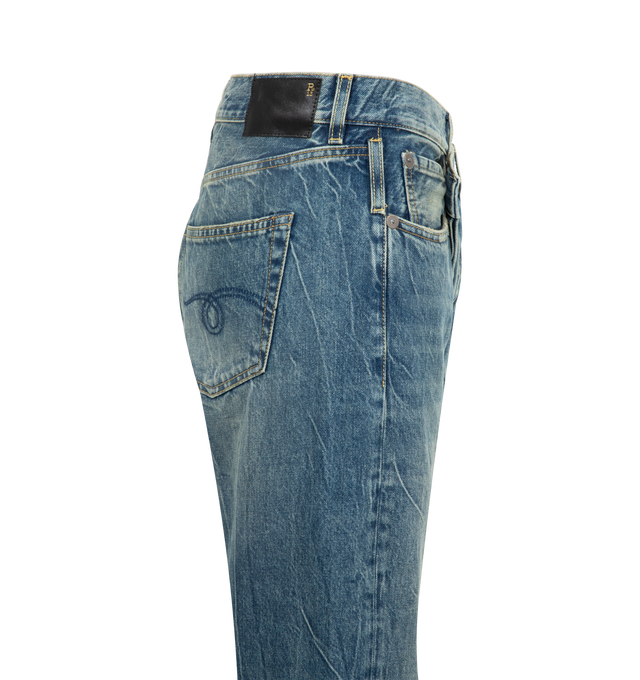 Image 3 of 3 - BLUE - R13 Crossover Jeans featuring fading, whiskering, and distressing throughout, belt loops, five-pocket styling, offset button-fly, raw edge at rolled cuffs and logo patch at back waistband. 100% cotton. Made in Italy.