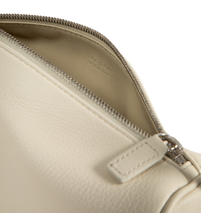Image 3 of 3 - WHITE - THE ROW 90'S Bag featuring top handle bag in finely grained calfskin leather with softly rounded edges, leather piping and adjustable slim leather strap. Measures 7.7 x 4.5 x 3 in. 100% calfskin leather. Made in Italy.