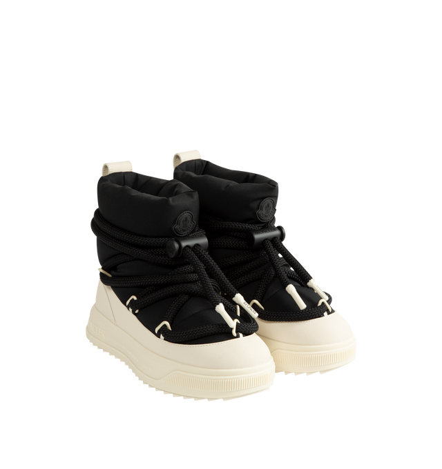 Image 2 of 4 - BLACK - Moncler Women's Altive Mid Snow Boots are designed with a boudin-quilted nylon upper and textured rubber overlays for lightweight protection and cold-weather performance. This mid-height silhouette features a wraparound drawstring fastening, pull tab at the backstay, and a round toe for comfortable everyday wear. Engineered with an EVA midsole and a Vibram MEGAGRIP tread for enhanced traction and durability, the style is finished with a lightweight TPU outsole for dependable grip in w