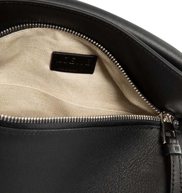 Image 3 of 3 - BLACK - LOEWE Small Puzzle Edge Bag in calfskin featuring geometric lines, cuboid form, overlapped panels with single stitch lines, shoulder, crossbody or hand carry, detachable and adjustable strap, zip closure with calfskin pull, one external zip rear pocket, one internal slip pocket, herringbone cotton canvas lining and embossed Anagram. Soft grained calf. 16.5 cm x 24 cm x 10.5 cm. Made in Spain.