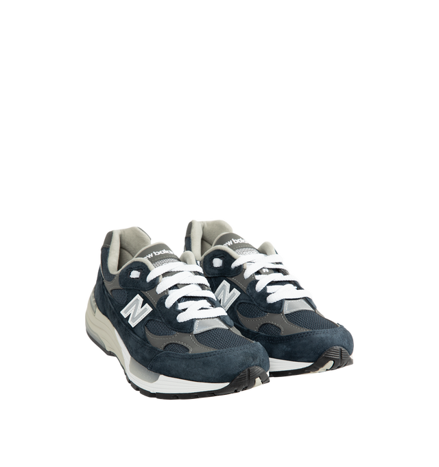 Image 2 of 5 - NAVY - New Balance Unisex Made in USA 992 Core Sneakers feature a mesh upper with premium suede overlays. ABZORB cushioning at the heel and forefoot absorbs impact, while a combined ENCAP and C-CAP midsole provides support. Reflective details and an Ndurance rubber outsole complete the design. Upper: Mesh and Suede. Sole: Rubber. Made in USA with 70% or more domestic value. *Unisex style in men's sizing.
