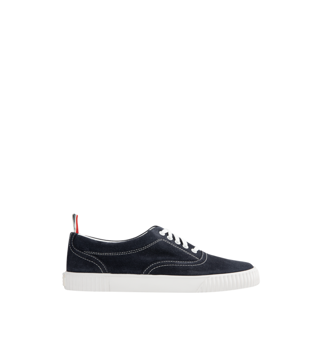 Image 1 of 5 - NAVY - THOM BROWNE Suede Heritage Trainer featuring lace up closure, rubber sole, leather lining and signature striped grosgrain loop tabs. Suede leather. Made in Italy.