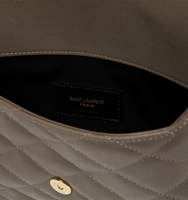 Image 3 of 3 - BROWN - Saint Laurent Womens Envelope Pouch is crafted from lambskin leather. Features the signature CASSANDRE logo, diamond-quilted topstitching, snap-button closure, cotton lining, and bronze-tone hardware. Dimensions: 27 16 1 cm. Main Material: Lambskin Leather; Hardware: Brass; Lining: Cotton. Made in Italy.