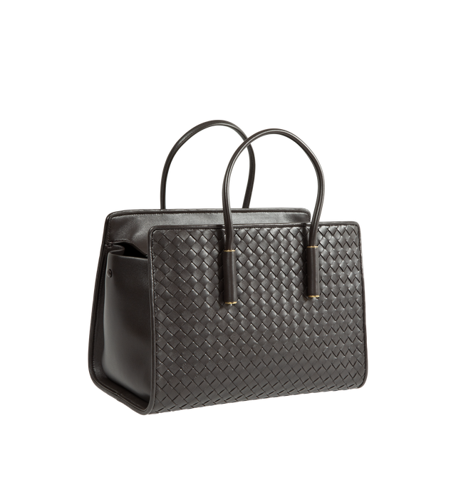 Image 2 of 3 - BROWN - Bottega Veneta Women's Small Intrecciato Leather Tote Bag is crafted from supple Intrecciato nappa leather and features a streamlined silhouette, a single-compartment interior, and a zip-top closure. Designed with snap-button attachments for the Dustbag Organizer system, it is finished with one interior zip pocket, an internal hand mirror with a leather cover, lambskin lining, and Brass Vibrato-finish hardware. Main Material: Intrecciato Nappa Leather. Lining: Lambskin. Hardware: Bras