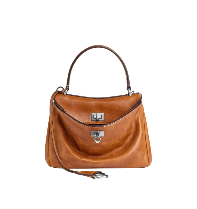 Image 1 of 4 - BROWN - BALENCIAGA Rodeo Handbag Mini featuring vegetal tanned lambskin, one handle hand carry, adjustable and removable crossbody strap, removable cloche cls with two split rings, aged-silver hardware, turn lock closure, wide front pocket, 1 main compartment, 2 flat pockets at back, side snaps, 4 brass feet and nappa lambskin lining. Lambskin. Made in Italy.