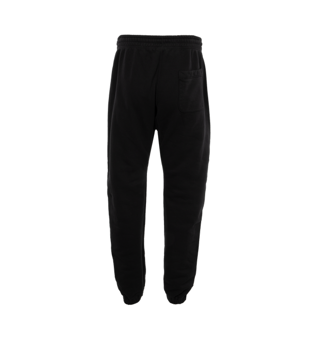 Image 2 of 4 - BLACK - SAINT MICHAEL Logo Sweatpants featuring jersey texture, elasticated waistband, two side welt pockets, logo print to the front, elasticated ankles, rear patch pocket and drawstring waist. 89% cotton, 8% polyester, 3% rayon. 