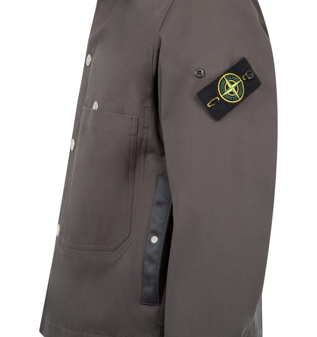 Image 3 of 3 - GREY - STONE ISLAND Coach Jacket featuring snap-fastened throat latch under collar to wear standing, waist-level top-entry patch pockets, vertical hand pockets with tape trim and concealed snap, three internal top-entry pockets; one with snap fastening that is visible on the exterior, Stone Island badge on left sleeve, adjustable cuffs with snap and snap fastening. 100% cotton.