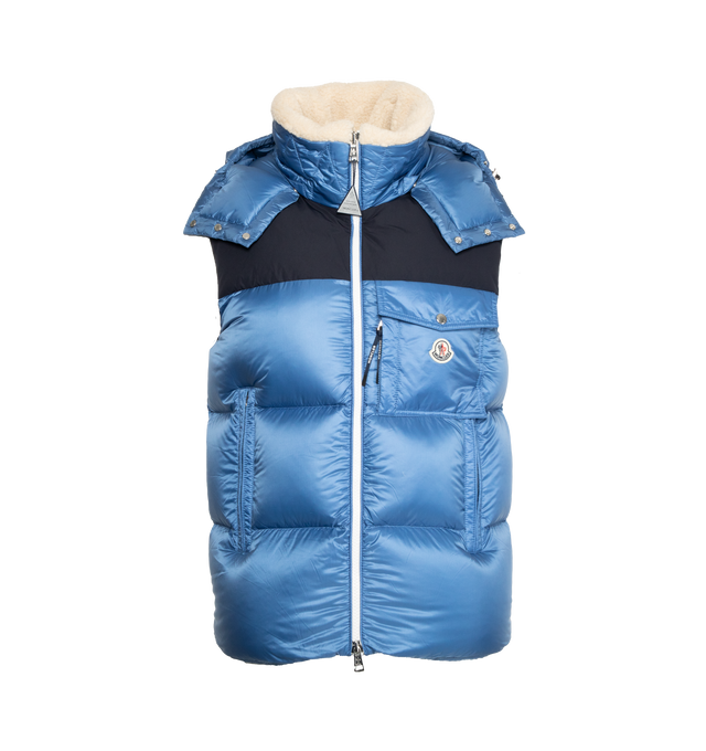 Image 1 of 3 - BLUE - MONCLER Oust Down Gilet featuring recycled micro ripstop lining, down-filled, detachable and adjustable hood with teddy lining, zip closure, zipped pockets, patch pocket on the chest and elastic armholes and hem. 100% polyamide. Collar: 79% polyester, 21% wool. Yoke: 100% polyester. Padding: 90% down, 10% feather. 