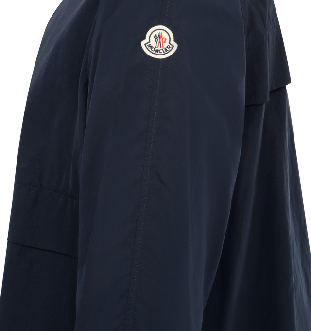 Image 2 of 2 - NAVY - MONCLER Rastaban Packable Jacket featuring water-repellent main fabric, packable in a crossbody bag with an adjustable shoulder strap, zipper closure, zipped pockets, elastic cuffs, hem with drawstring fastening and logo patch. 100% polyamide/nylon. Made in Romania.