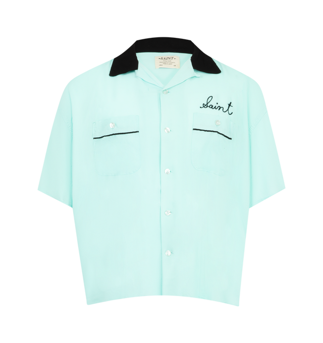 Image 1 of 2 - BLUE - SAINT MICHAEL Trump Bowling Shirt featuring contrast collar, chest embroidery script, two front pockets with black piping, short sleeve button-up and relaxed boxy fit. 100% cotton. Made in Japan.