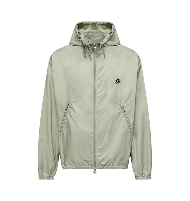 Image 1 of 1 - GREEN - Moncler Men's Hooded Windbreaker is crafted from water-repellent rainwear nylon and features an oversized silhouette, an adjustable hood, and a front zip closure. Inspired by a spirit of exploration, this lightweight outerwear style balances functional protection with a refined contemporary aesthetic. Designed with zipped pockets, elastic cuffs, and an elasticized hem, it is finished with a vintage-inspired metal logo that references Moncler's alpine heritage. Main Material: 100% Poly