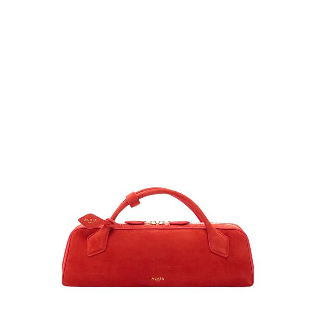 Image 1 of 1 - ORANGE - Azzedine Alaia clutch version of the emblematic Le Teckel bag crafted from suede goatskin leather featuring an elongated shape, tubular short handles with decorative ties, double zip closure, small removable mirror on the inside pocket. Material: Leather. Dimensions (cm) : L 31 X H 10 X D 7. Made in Italy.